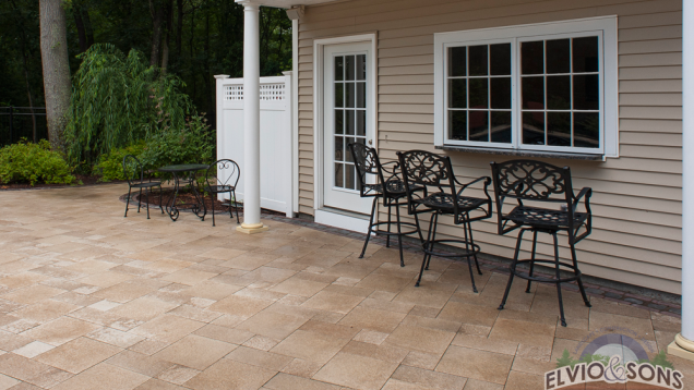 Outdoor bar in pool house over Unilock patio.