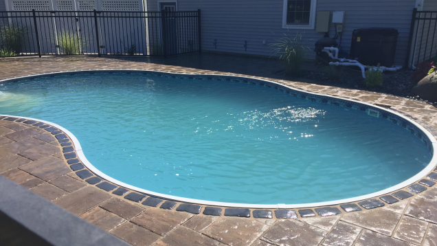 Paver patio and in-ground liner pool coping.