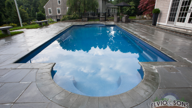 Blue stone patio and in-ground pool in North Kingston, RI.