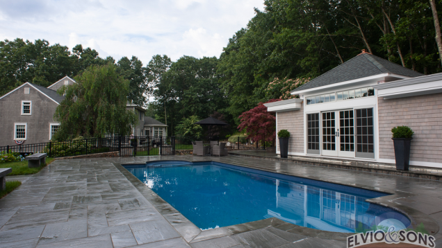 Blue stone patio and in-ground pool in North Kingston, RI.